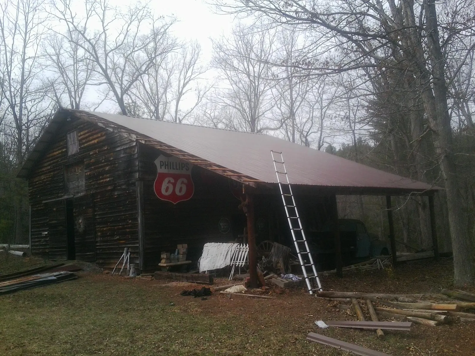 New metal roof on an open sided timber barn with a vintage sign in Amherst